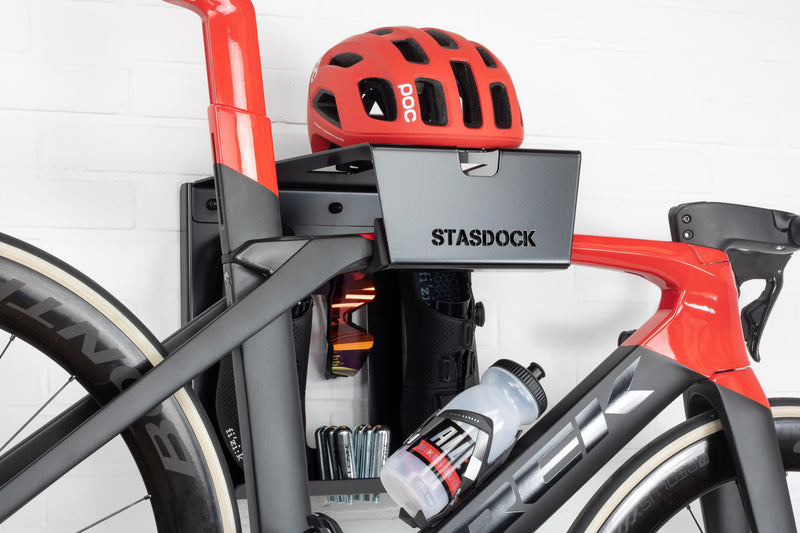black stasdock bike wall mount attached to racing bike with bicycle accessories