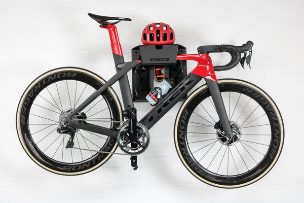 black stasdock bike wall mount attached to racing bike